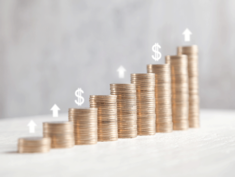 Coin stacks dollar signs and up arrows