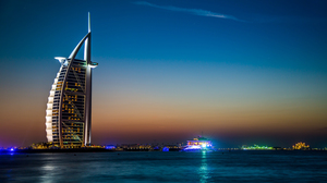 Skyline at twilight with lights reflecting on the water.